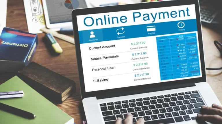 A laptop screen displaying an online payment dashboard with account balances and transaction details.